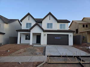 View of front of house with a garage and covered porch