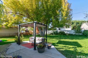 View of yard featuring a pergola and a patio