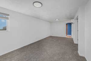 Carpeted empty room with a wall mounted AC