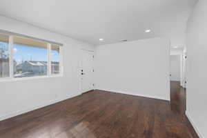 Spare room featuring dark hardwood / wood-style flooring