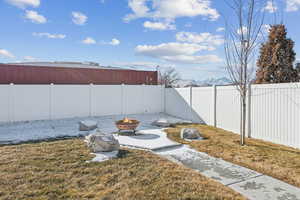 View of yard with an outdoor fire pit