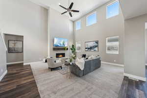 Living room with dark wood-type flooring and ceiling fan