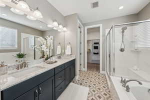 Bathroom with vanity and shower with separate bathtub