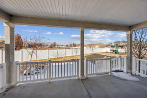 Snow covered patio featuring a playground