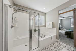 Bathroom featuring tile patterned floors and plus walk in shower