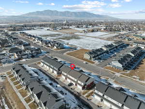 Snowy aerial view featuring a mountain view