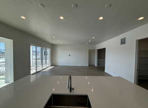 Kitchen featuring sink, wood-type flooring, and a textured ceiling