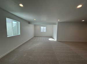 Carpeted empty room with a textured ceiling