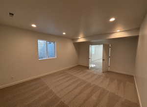 Spare room featuring light colored carpet