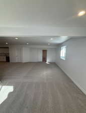 Basement featuring carpet and sink