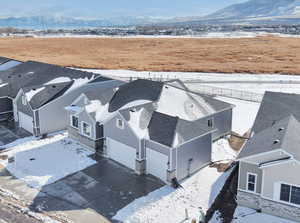 Snowy aerial view with a residential view and a mountain view