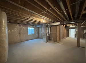 Basement featuring heating unit