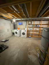 Basement featuring washing machine and clothes dryer and water heater