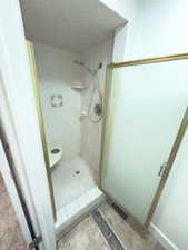 Bathroom featuring a tile shower