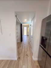 Hall featuring light hardwood / wood-style flooring