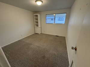 Spare room featuring carpet flooring