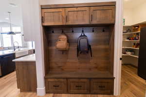 Mudroom featuring sink and light wood-type flooring