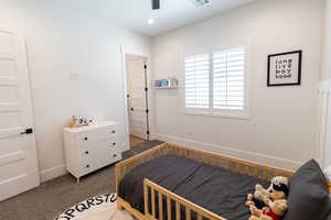 Bedroom featuring dark colored carpet