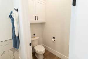 Bathroom featuring hardwood / wood-style floors and toilet