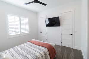 Carpeted bedroom with ceiling fan