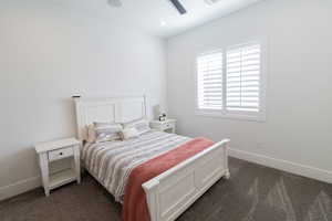 Carpeted bedroom with ceiling fan