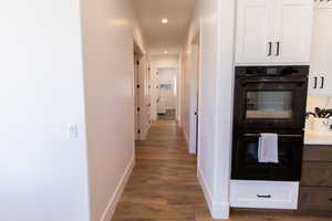 Corridor with dark wood-type flooring