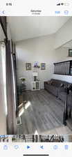 Living area featuring wood finished floors and vaulted ceiling