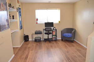 Office space with light hardwood / wood-style flooring