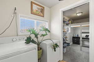 Laundry room with carpet flooring and washing machine and dryer