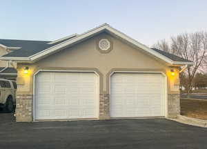 View of garage at dusk