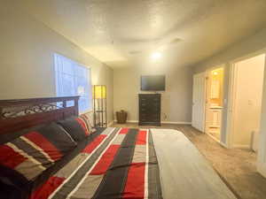 Bedroom featuring ceiling fan, carpet flooring, and a textured ceiling