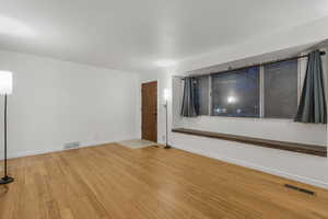 Spare room with wood-type flooring