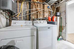 Clothes washing area featuring washing machine and clothes dryer