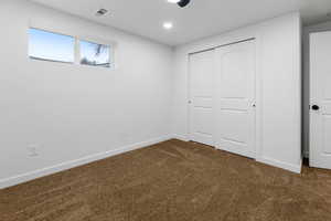 Unfurnished bedroom with a closet and carpet