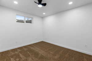 Carpeted spare room with ceiling fan