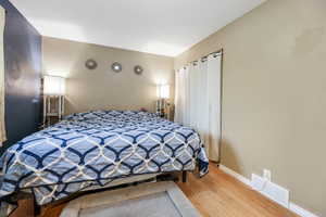 Bedroom with hardwood / wood-style flooring