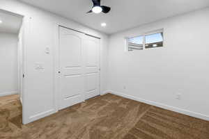 Unfurnished bedroom with a closet, ceiling fan, and carpet flooring