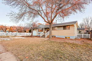 View of front of home with a garage and a front yard