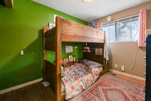 Bedroom with hardwood / wood-style floors