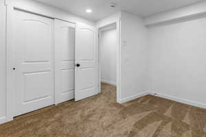 Unfurnished bedroom with carpet and a closet