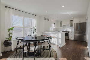 Dining room emphasizing the light and bright layout.