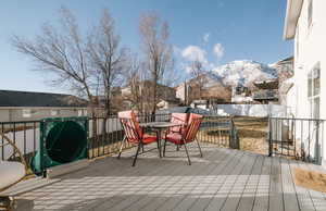 Snow covered deck with a mountain view