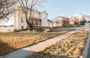 Front of property with a mountain view and a front yard.