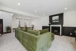 Carpeted living room with a fireplace.