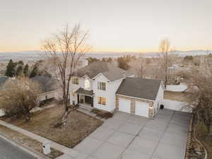 View of front of house with a sunset view and a garage.