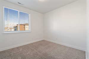 Bedroom #3. Spare room with carpet and large window.