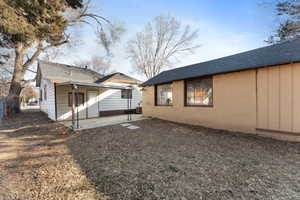 Rear view of house featuring central AC and a patio