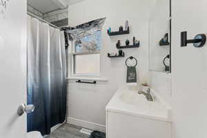 Bathroom with vanity and a shower with shower curtain