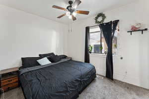 Carpeted bedroom with ceiling fan