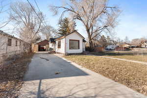 View of side of home with a lawn